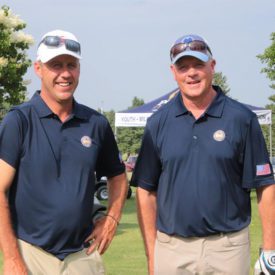 Two golfers smiling at camera