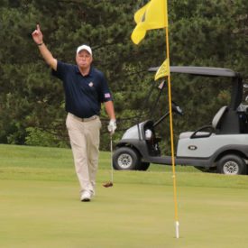 Golfer raising up hand in excitement